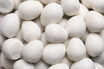 Peeled boiled quail eggs as background, top view