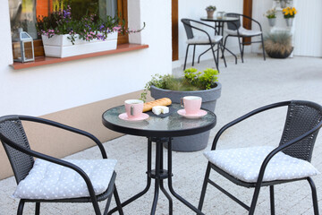 Cups of coffee, bread and cheese on glass table. Relaxing place at outdoor terrace