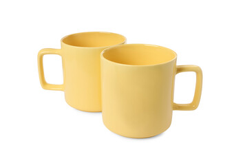 Two yellow ceramic mugs isolated on white