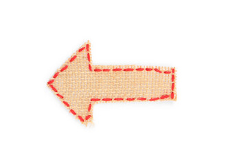 Arrow made of burlap fabric with red stitches isolated on white, top view