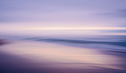 Pink sunset over the sea. Beautiful abstract seascape in light blue and pink colors, motion blur