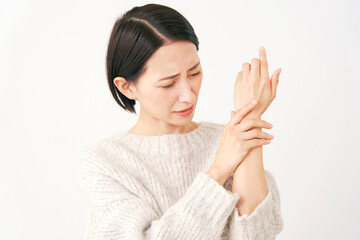 手が痺れる中年女性　白背景