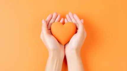 Foto op Aluminium Woman's hands with pastel manicure forming a heart on orange background. Flat lay style - Generative AI © seogi