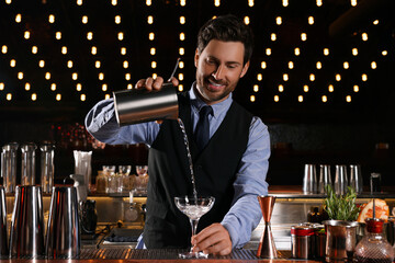 Bartender preparing fresh alcoholic cocktail in bar
