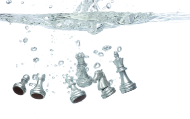 Silver Chess many Figure throw fall into clear water with air bubble. Unpredictable failure of business plan strategy and human resources organization risk management. White background isolated