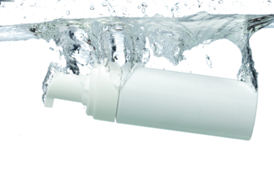 Cosmetic container fall into clear water with air bubble. Pump cosmetic treatment container drop to clear water of freshness. White background isolated freeze element