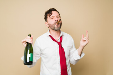 Handsome man looking drunk and smoking a cigar