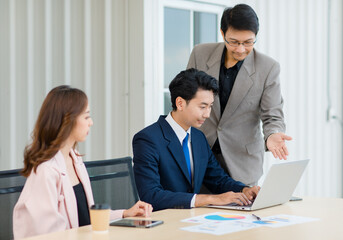 Fototapeta premium Asian professional successful male female businessmen businesswomen employees staffs in formal business suit outfit sitting standing important job deal done together