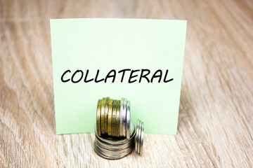 Collateral word, text on a sheet with coins. Collateral financial concept.