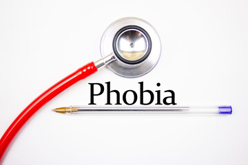 PHOBIA text, inscription on a white background with a stethoscope. Phobia, medical concept.