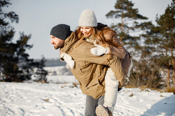 Young man and woman spending time together at winter day