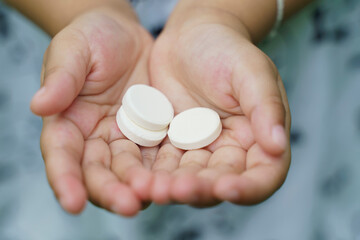 close up of medical pills, Multivitamin pill containing amino acid on child hand.