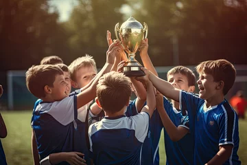 Tuinposter children kids tournament sport team winning championship football soccer celebrating trophy holding players young achievement sports boys boy cup champion youth league succeed game © sandra