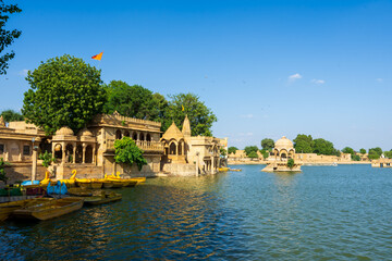 Stone towers of the sacred Gadisar Lake. Jaisalmer Fort (Sonar Quila or Golden Fort) is located in...