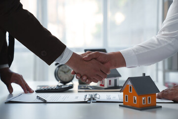 House developers and customer shaking hand after accept agreement finish buying or rental real...