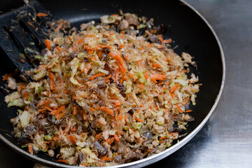 Stuffed spring rolls are cooked in a pan