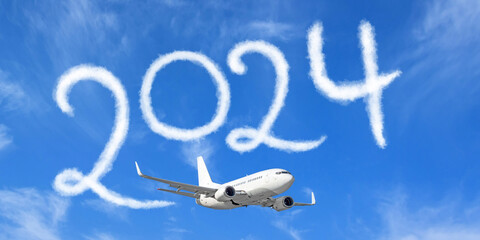 Happy New year 2024 on the background below cloudscape. Drawing by passenger airplane vapor...