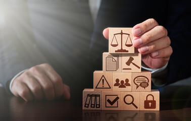 Lawyer advising on laws related to business. Businessman stacking wooden blocks. Scale balance icon and lens flare light.