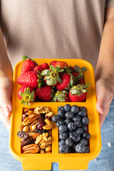 Person showing a plate with healthy breakfast