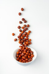 Pile of hazelnuts isolated on white background