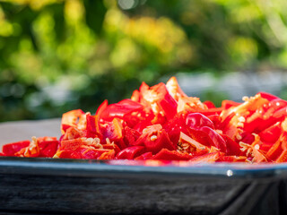 Red hot Chili fruits cut on plate in close up view