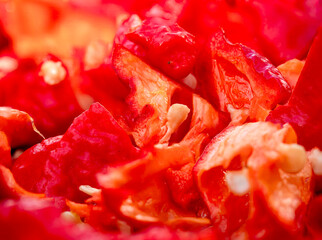 Red hot Chili fruits cut on plate in close up view