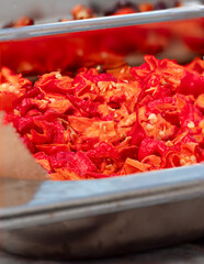 Red hot Chili fruits cut on plate in close up view
