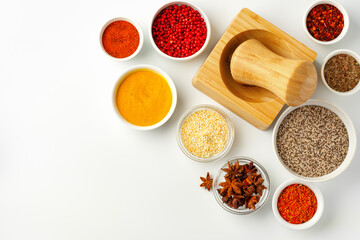 Wooden mortar with spices on white background