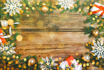 Fototapeta na wymiar Beautiful Christmas composition festive decorations and space for text on wooden table, flat lay. Bokeh effect