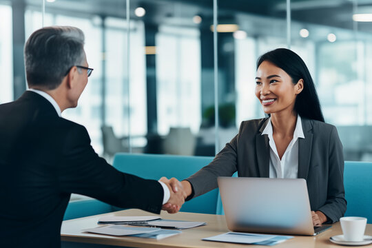 Woman accepting business deal, handshake with client and colleague