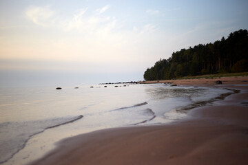Amazing calm scenery of a blue sky and tranquil sea with light fog above, selective focus