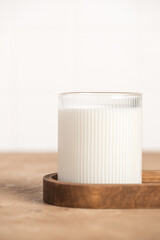 Milk in a glass, bottle of milk, light stylish kitchen