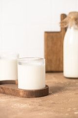 Milk in a glass, bottle of milk, light stylish kitchen