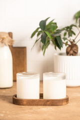 Milk in a glass, bottle of milk, light stylish kitchen