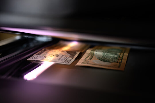 Using a copy machine to print forgery currency. 