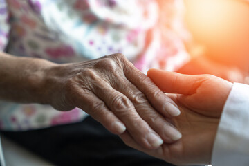 Parkinson disease patient, Alzheimer elderly senior, Arthritis person's hand in support of nursing family caregiver care for disability awareness day, National care givers month, aging society concept - obrazy, fototapety, plakaty