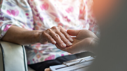 Parkinson disease patient, Alzheimer elderly senior, Arthritis persons hand in support of geriatric doctor or nursing caregiver in hospice palliative care, disability awareness day, aging society - obrazy, fototapety, plakaty
