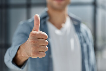 portrait and thumbs up for success standing at modern office