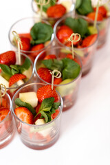 portions of fruit in glasses, strawberries and pineapple, buffet table, waiting for guests