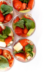 portions of fruit in glasses, strawberries and pineapple, buffet table, waiting for guests