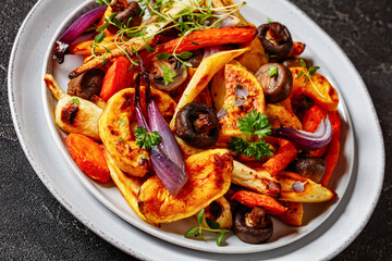 baked winter veggies and mushrooms on a plate