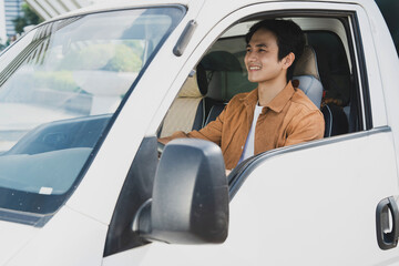 Photo of young Asian man with his truck - obrazy, fototapety, plakaty