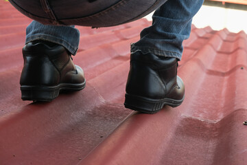 Wear safety shoes to ensure safety at work. construction workers wear safety shoes. People with...