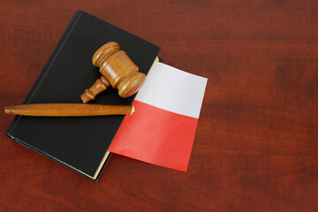 Broken judge gavel and legal book with flag of Poland. Copy space for text.