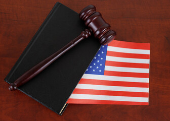 Legal book with USA flag and wooden judge gavel. US legal system concept.