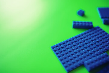 A scattering of constructor elements for children. Colored blue bricks from the puzzle.
