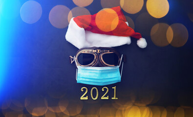 Christmas or New Year celebration concept. Santa Claus hat, glasses and nose with face mask on red...