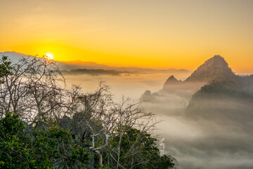 Aerial view of flowing fog  on mountain tropical rainforest in the morning