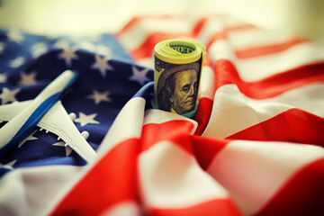 American striped flag and a stack of one hundred dollar bills. Financial center of the world.