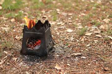 Camp fire equipment with a small fire pit in the middle of a field